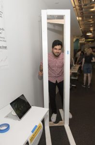Student interacting with a student project which includes a physical installation at IDM showcase 2018