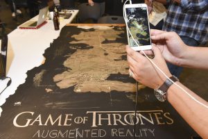 Student interacting with a mobile AR game of thrones themed project at IDM showcase 2017