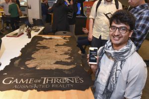 student presenting their mobile AR game of thrones themed project at IDM showcase 2017