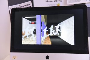 Student project on a monitor at IDM showcase 2017 showing white body shadows jumping in front of a subway train