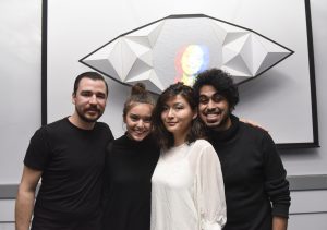 Students standing with a project which includes an eye shaped physical installation at IDM showcase 2017