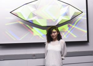 Student presenting a project which includes an eye shaped physical installation at IDM showcase 2017