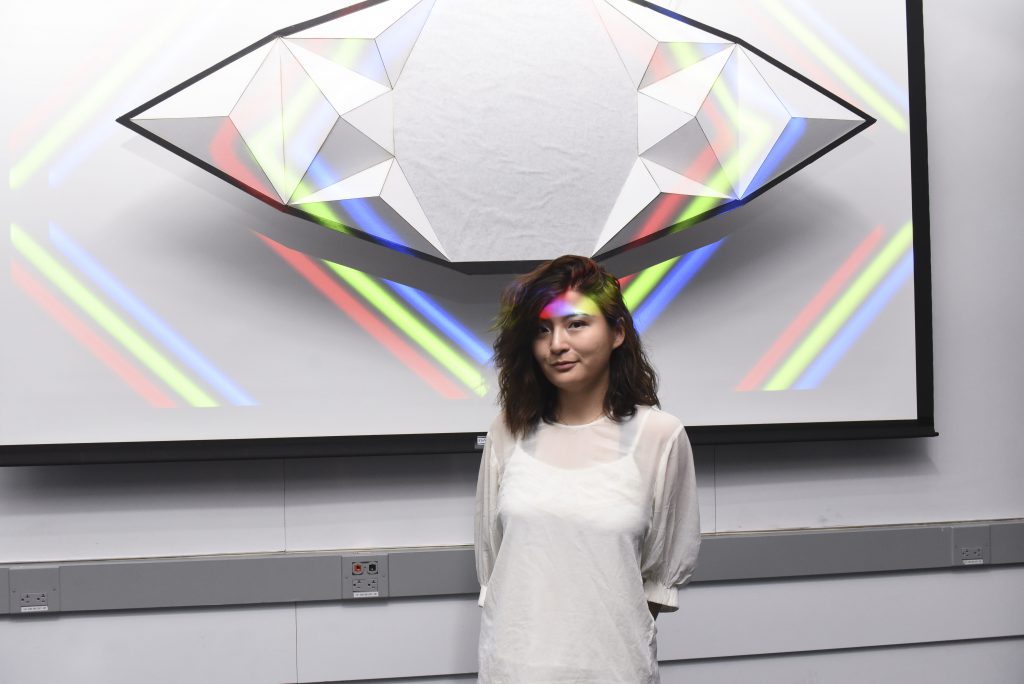 Student presenting a project which includes an eye shaped physical installation at IDM showcase 2017