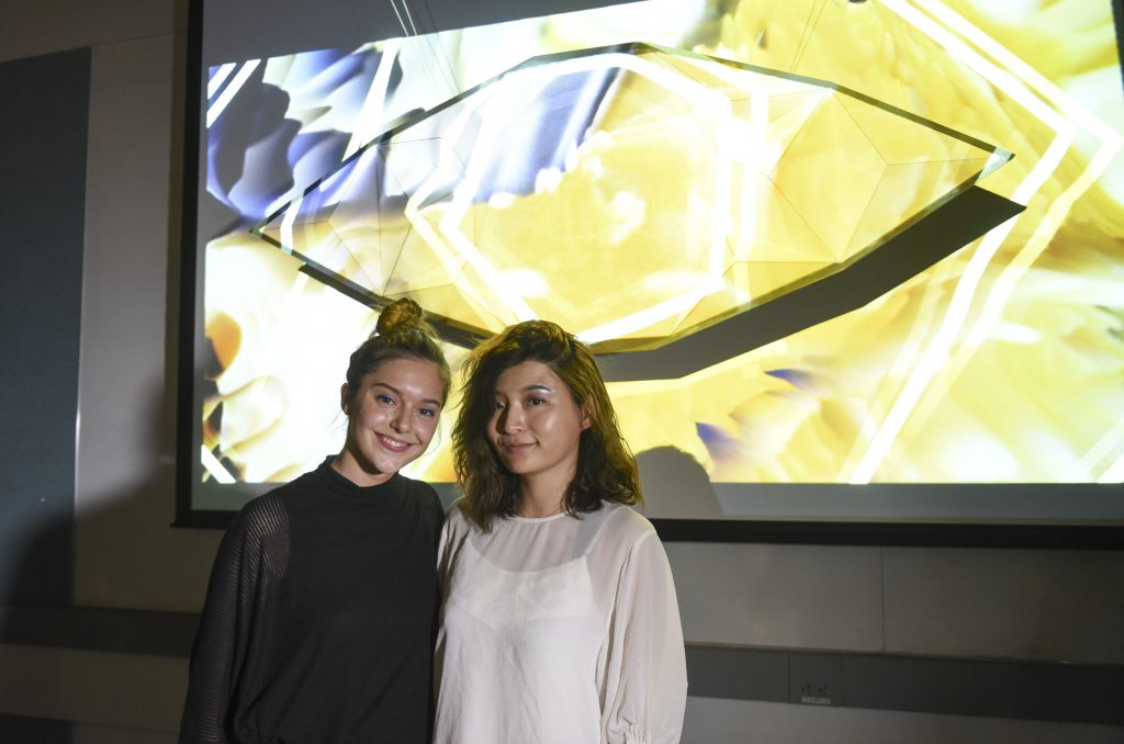 Students standing with a project which includes an eye shaped physical installation at IDM showcase 2017