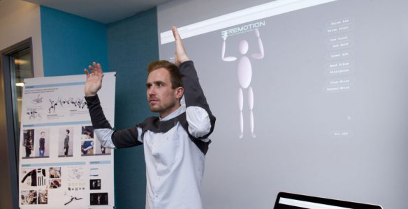 student demonstrating their motion capture project at the IDM showcase