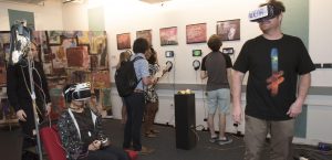 Professors and students interacting with student projects at IDM showcase 2018