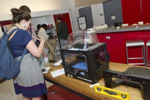 Student interacting with a project with a 3D printer at IDM 2015 showcase