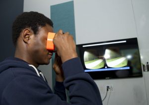 student interacting with a VR project at IDM 2016 showcase